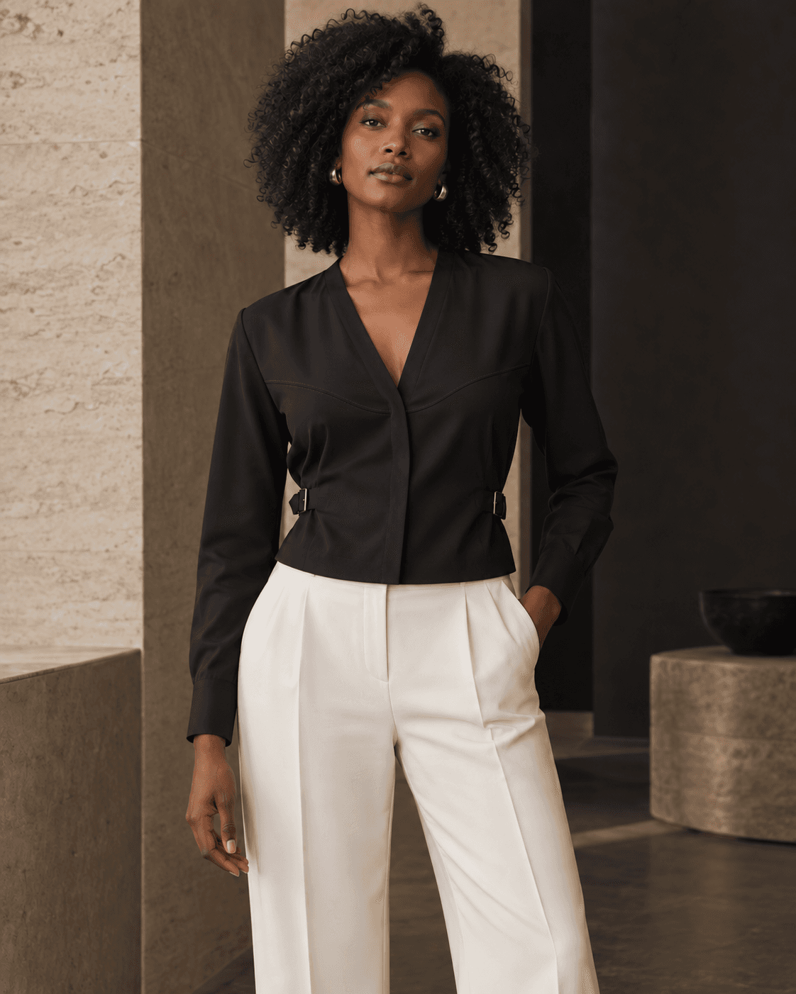 Model in a dark formal Shirae with ivory tailored trousers